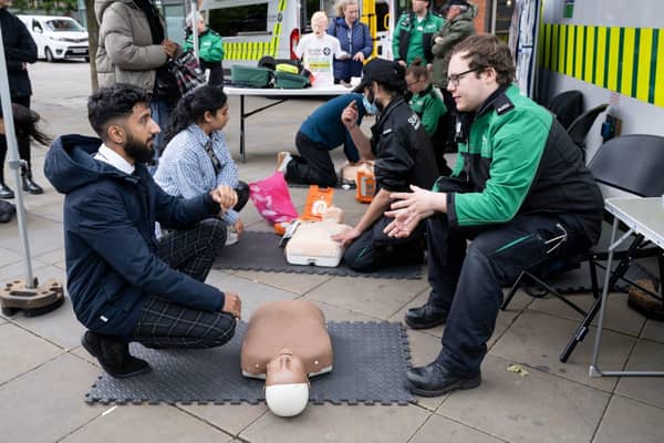 Demonstrating how to deliver CPR and use a defibrillator