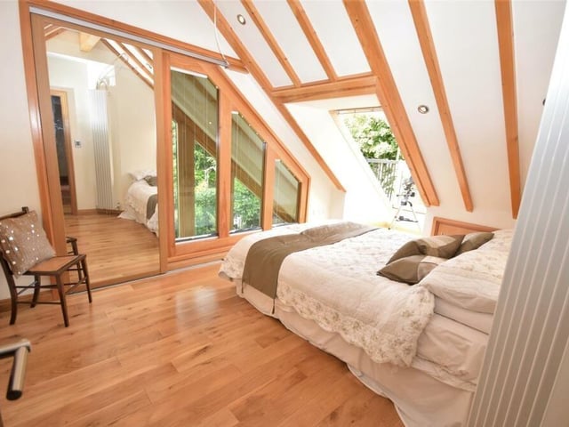 The second bedroom is a stunner, thanks to its stylish design features. There are superb internal windows and a pop-out balcony roof window, which add air and light, as well as fine views across the rooftops. A built-in wardrobe provides storage, while the floor is made of solid oak wood.