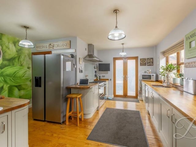 The kitchen has space for a fridge freezer and also a small breakfast bar with stools. There is easy access to a utility room too.