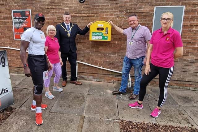The new defibrillator for public use outside The Fitness Box gym is unveiled by, from left, gym owner Lloyd Scott, fitness instructor Carol Atherton, the Deputy Mayor of Mansfield, Cllr Craig Whitby, local councillor David Coxhead and Joanne Bradford, of the gym.