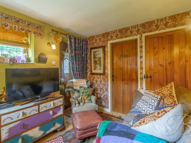 Here is the second living room, or snug, on the ground floor. There is a cupboard for storage and while one door leads outside, the other leads to a WC.