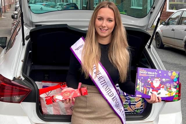 Beauty queen Nikita Wilson with some of the chocolates and selection boxes that have been donated for children spending this Christmas at King's Mill Hospital in Sutton.