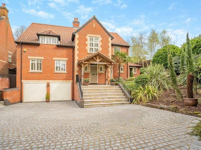 Back to the front now to show a block-paved driveway offering off-street parking space and leading to a substantial double garage, equipped with power, light and heating and accessed by remote-controlled, electric doors. The front door of the house sits beneath a large, oak canopy storm porch accessed via stone steps with black wrought-iron handrails either side.