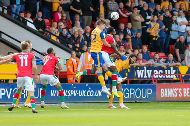 Mansfield Town striker Oli Hawkins rises highest to win the ball at Walsall.