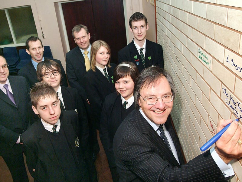 In 2008, Mike Collins from the St. James's Place Partnership added his name to the sponsorship wall at Quarrydale School after they successfully achieved Science status. He was joined by, from left to right in the back row, Deputy Head Martin Brookes, Head Teacher Craig Weaver, and Ian Baggaley, Managing Director of Baggaley Construction, along with pupils who also pledged their support.