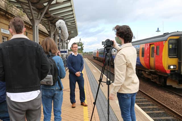 Students interviewing Mansfield mayor Andy Abrahams at the train station for the final film
