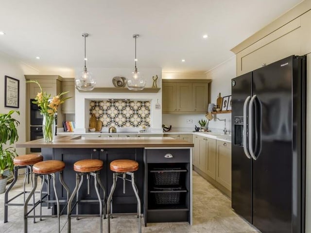A striking feature of the kitchen is the space for a huge American fridge/freezer. There is also space for stools by the central island, while the floor is tiled and 12 spotlights look down from the ceiling.