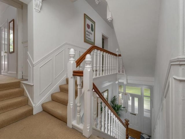 This is the galleried landing on the first floor. It features an exotic stained-glass window to the front of the property.