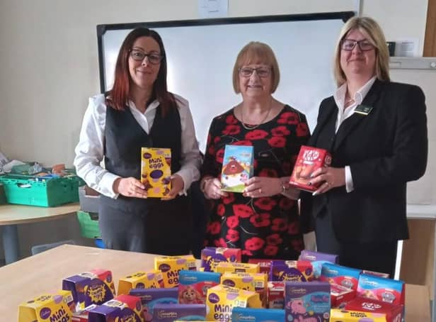 From left: Carol Inquieti, office administrator at Gillotts Funeral Directors, Susan Bagshaw, manager of the Eastwood Food Bank, and  Helen Ellis, a funeral director at Gillotts, with the chocolate eggs that the firm donated to the food bank for local children.