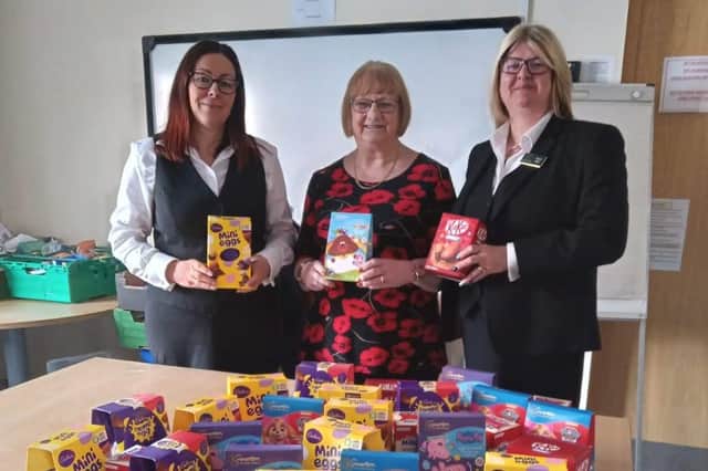 From left: Carol Inquieti, office administrator at Gillotts Funeral Directors, Susan Bagshaw, manager of the Eastwood Food Bank, and  Helen Ellis, a funeral director at Gillotts, with the chocolate eggs that the firm donated to the food bank for local children.