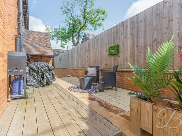 Part of the two-tiered garden at the back of the house is devoted to this decked seating area.