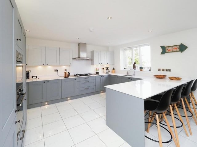 The classy kitchen/diner screams modernity. Contemporary units blend perfectly with integrated appliances.