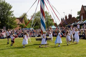 Big crowds watch children dancing around the maypole at Wellow's traditional event on Bank Holiday Monday.