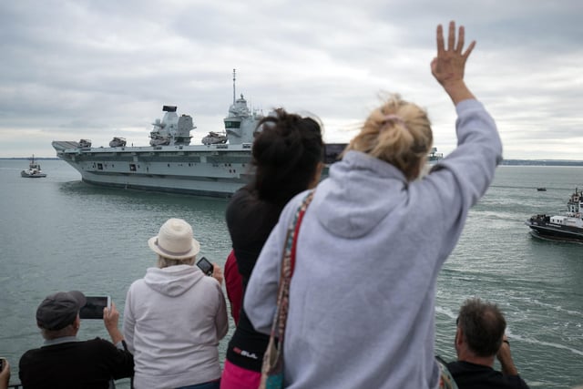 People wave from the Round Tower in Old Portsmouth as HMS Queen Elizabeth departs. Picture: Andrew Matthews/PA Wire