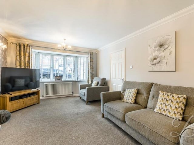 Next stop at the £360,000-plus property is this spacious living room, complete with a magnificent bay window that overlooks the front of the house.