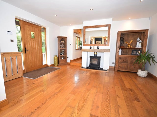 Through the front door and into this vast reception hall. Its combination of character and contemporary finishes sets the tone for the rest of the property. The space, with its solid oak floor and atmospheric dpwnlighting, could even be used as a dining area if you wish.