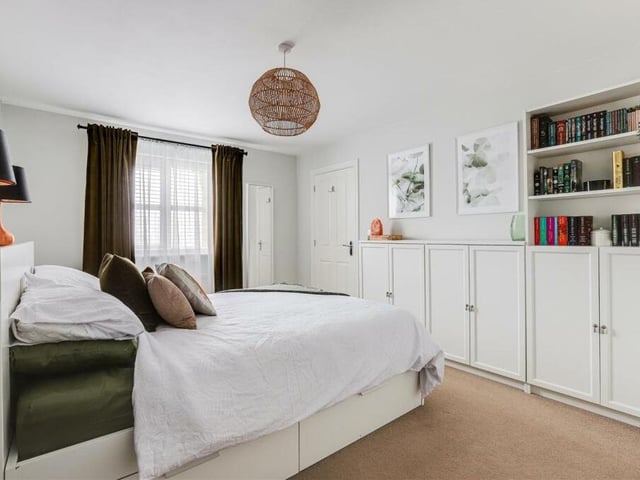 A third image of the master bedroom unveils a plethora of storage space.