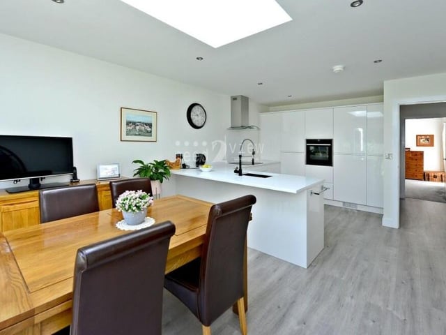 This photo shows how the diner sits next to the kitchen, with space for a dining table and TV.