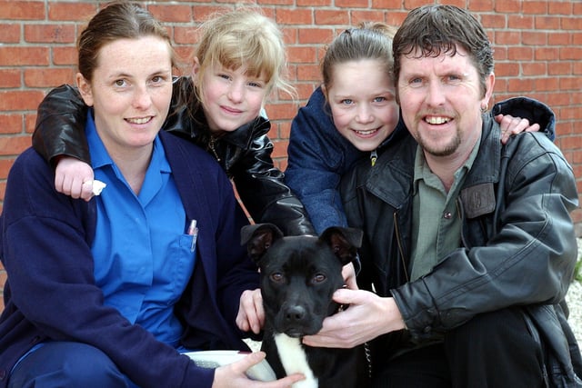 Allan Stanley and his two daughters April Stanley, 7 and Abigail Stanley, 11 re-united with their pet dog George at the PDSA petaid hospital, Newhall Road, Atlas, Sheffield back in 2004 after his identity came up after he was tagged. Vet Nurse Natalie Cowley, pictured with the happy family.
