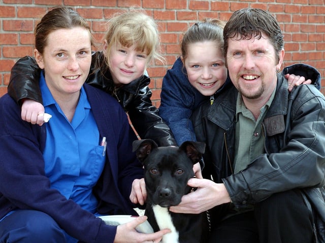 Allan Stanley and his two daughters April Stanley, 7 and Abigail Stanley, 11 re-united with their pet dog George at the PDSA petaid hospital, Newhall Road, Atlas, Sheffield back in 2004 after his identity came up after he was tagged. Vet Nurse Natalie Cowley, pictured with the happy family.