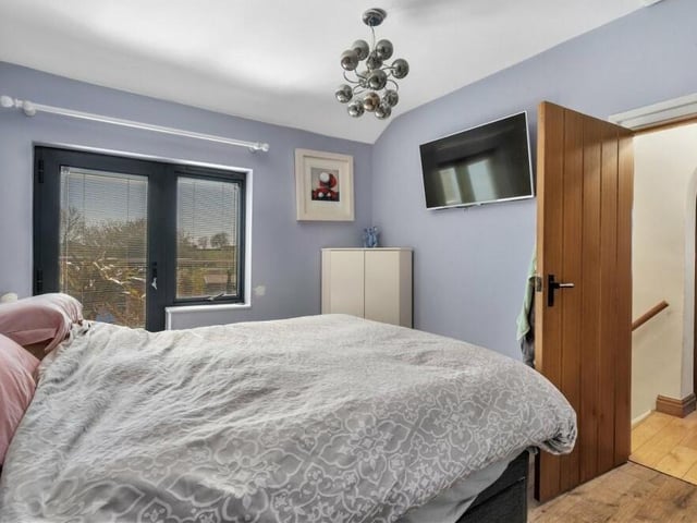 Time to move upstairs to look at the four bedrooms, starting with the master, which has a skylight and a door leading to a balcony. There is also a walk-in wardrobe, and ladder access to a loft.