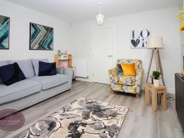 A second shot of the lounge, with its warm and homely tones and luxury vinyl tiled flooring.