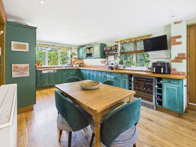 At the heart of the home is a superb open-plan dining kitchen, equipped with underfloor heating and a comprehensive range of fitted units topped with timber-finish worktops.