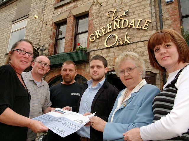 The landlady and landlord of the Greendale Oak, Tracey and Andrew Parr, left, and event organiser John Naish, third left, hand over the proceeds of a charity race night to family members of John Kerrigan who died from leukaemia. John's son Tom, his mother Kate and wife Lesley received the £1300 cheque in his memory on behalf of Leukaemia Research. John had been an accountant with Anderson and Co, working at their offices in Worksop and Kirkby.