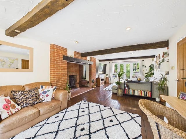 The lounge is packed with character including exposed timber flooring, ceiling beams and French doors opening directly out to the rear garden.