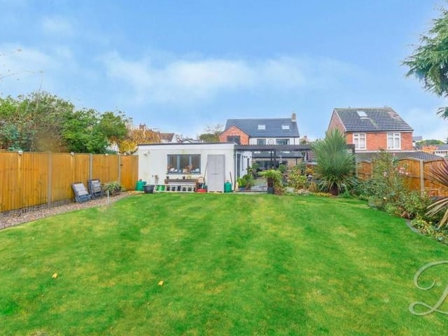 The last photo in our gallery reveals more of the garden, which features lots of decorative shrubbery.