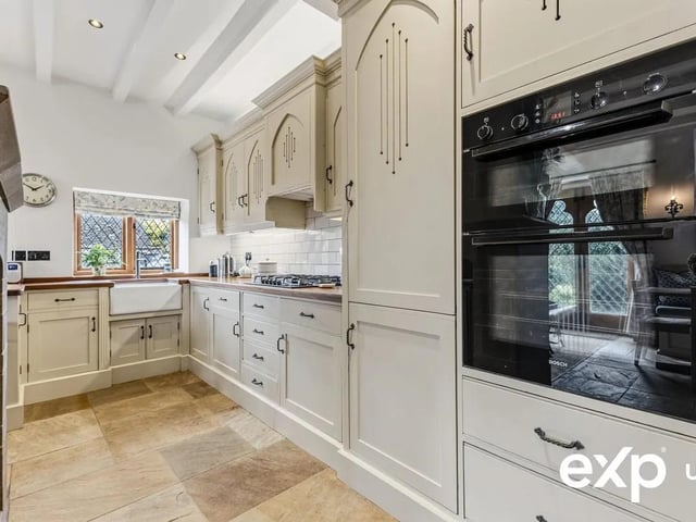 Quality appliances include a Bosch double oven, a Bosch five-ring gas hob with extractor above, a fridge, a freezer, a dishwasher and a washing machine