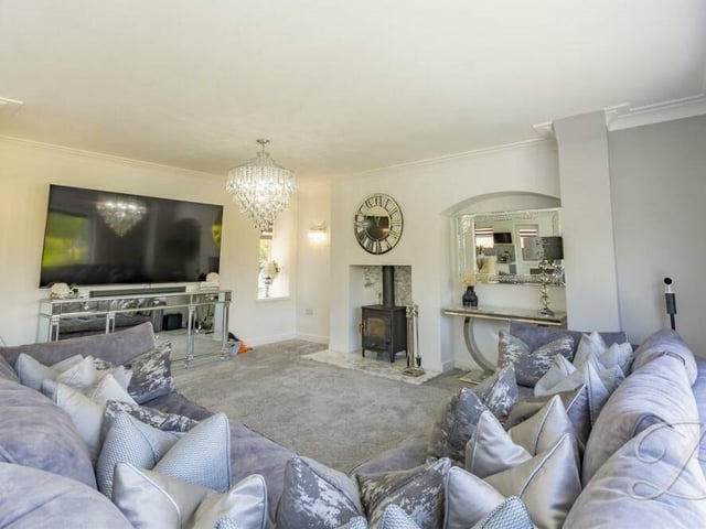 The open-plan living area comes with a log-burner and marble hearth, not to mention stylish wall-lights.