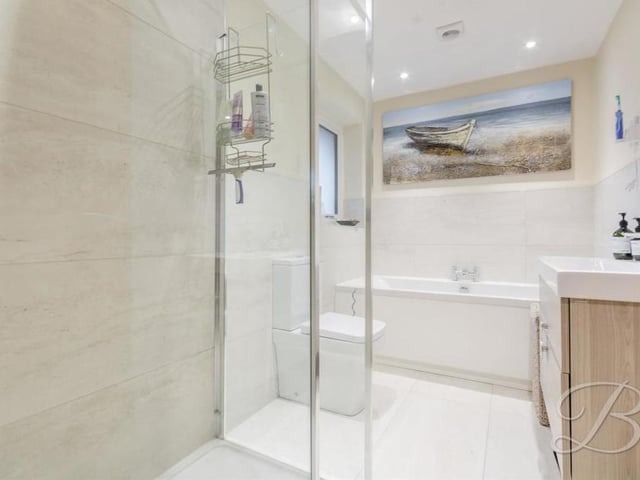 The family bathroom on the first floor is the last room to inspect. It is fitted with a panelled bath, enclosed shower, wash hand basin with vanity unit, and low-flush WC. Modern tiling, underfloor heating and downlights complete its squeaky-clean appearance.
