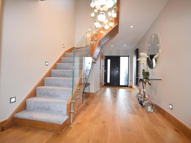 Back into the hallway now as we prepare to move upstairs. The staircase really helps to open up the soaring space, full of light.