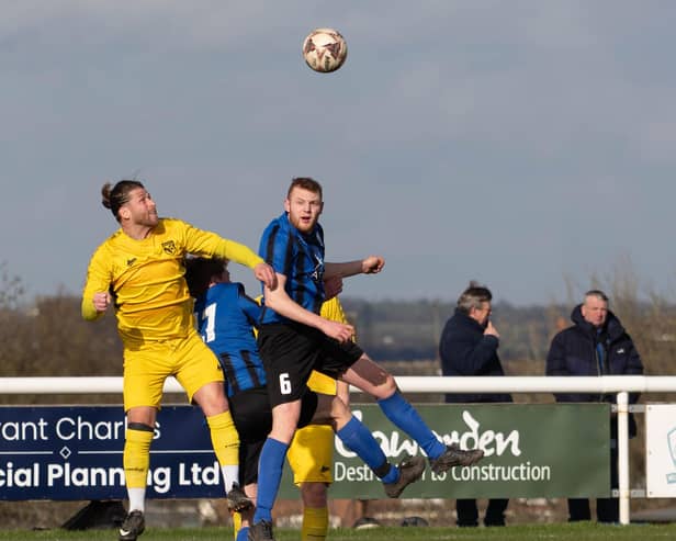 Ben Moore wins a header in the defensive half