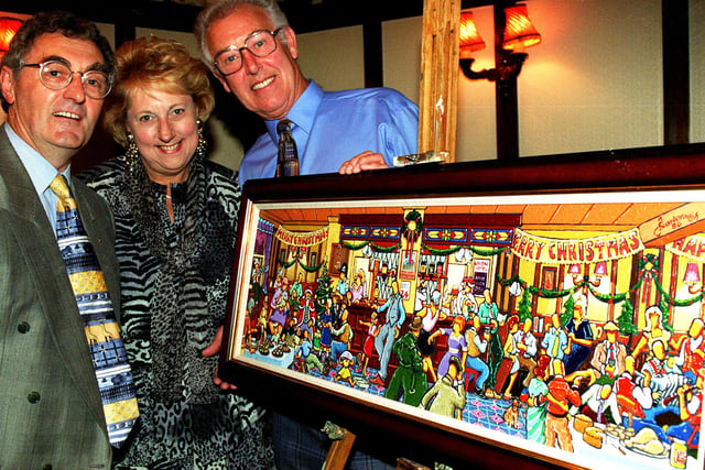 Joe Scarborough is pictured with his latest Christmas card design alongside the landlord and landlady of the Union Pub, Nether Edge, Paddy and Beryl Sullivan in 1996