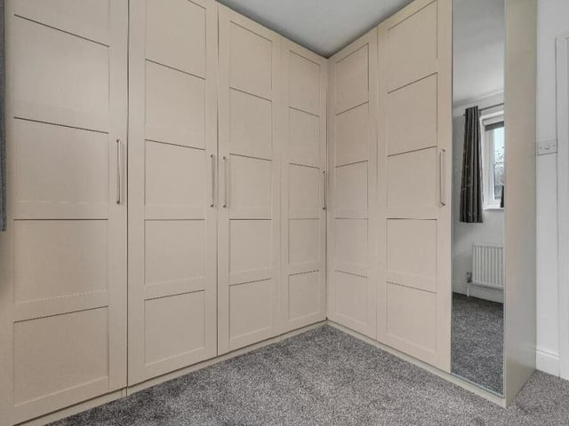 Two of the five bedrooms on the first floor are being utilised as dressing rooms, including this one. The current owners have recently built an L-shaped range of stylish wardrobes that are open for separate negotiation with buyers.