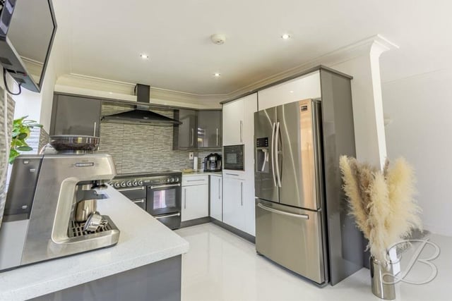 The kitchen/diner is fitted with an extensive range of modern gloss wall and base units with granite worktop over, inset sink and drainer. Appliances include a Rangemaster cooker set with extractor fan, an integrated microwave and an integrated dishwasher. There is space for a double fridge/freezer.