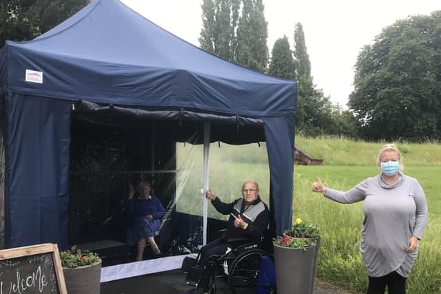 Ann Bailey and Fred Winters trying out the new visitor pod, with home manager Zoe Searston.