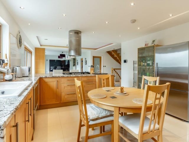 The huge kitchen features free-standing, stainless steel Fisher & Paykel appliances, comprising a two-drawer unit dishwasher and an American-style fridge/freezer. An inset ceramic  sink has a matching drainer and mixer tap.