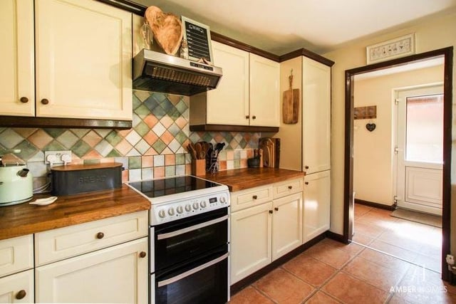The living room/diner leads on to the kitchen at the back of the house. It is fitted with a range of base, wall and drawer units with work surfaces over. A free-standing cooker, with four-ring gas hob and extractor over, fits in well.