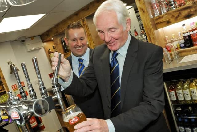 Club legend Sandy Pate pulling a pint in the bar named after him when it was re-opened following refurbishment