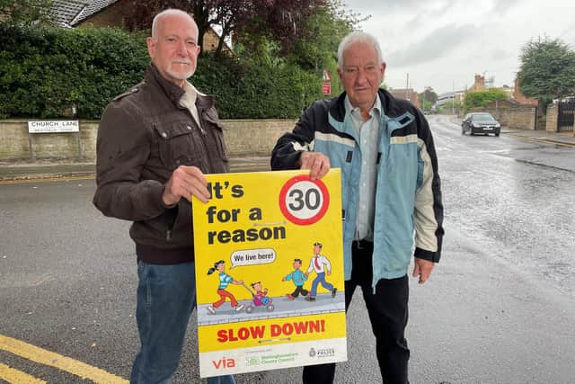Dave Hague and Mick Holmes are campaigning for a reduction in the speed limit and other measures to make the road safer.