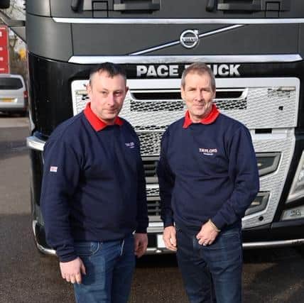 Mark Taylor truck driver and Peter Taylor (no relation) relief driver pose before setting off on their 1300 mile journey to Poland to deliver aid to the Ukrainian refugees.