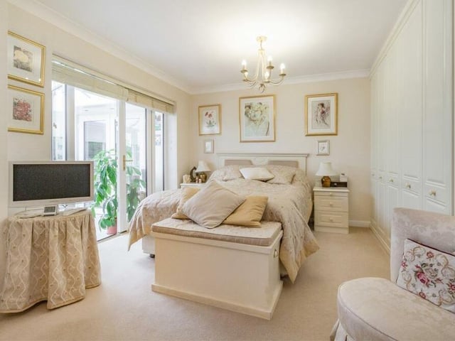 We move now into the master bedroom, which is an amalgamation of two bedrooms that can easily be reversed, if required. It includes an extensive range of fitted wardrobes with hanging rails and shelves, while French doors lead through to the conservatory.