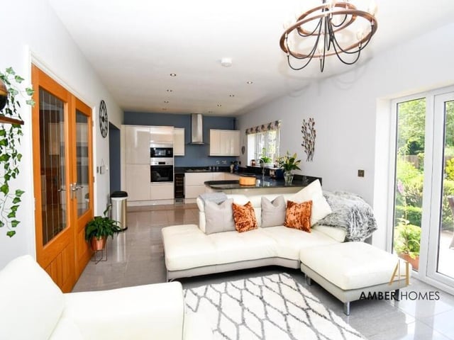 The open-concept living area on the lower floor is flooded with natural light, creating a bright and airy atmosphere. It serves as the heart of the home.