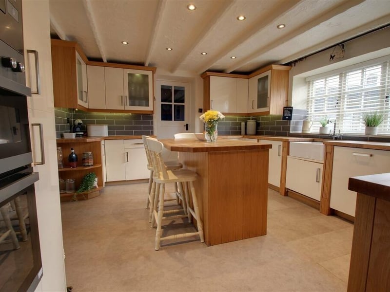 Integrated appliances in the kitchen and breakfast room include a double electric oven, a microwave, four--ring hob with extractor above, a dishwasher, fridge and freezer. It is a bright room thanks to a large window facing the front of the house