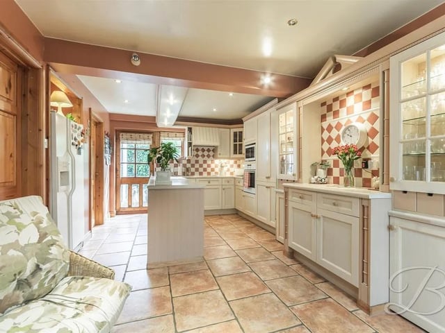 Complete with a range of matching cabinetry and maple worktop surfaces the kitchen features an inset sink and drainer, island and an integrated eye level oven.