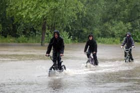 The A60 through Warsop flooded in June 2007. Were you one of these cyclists who decided to go for a swim?