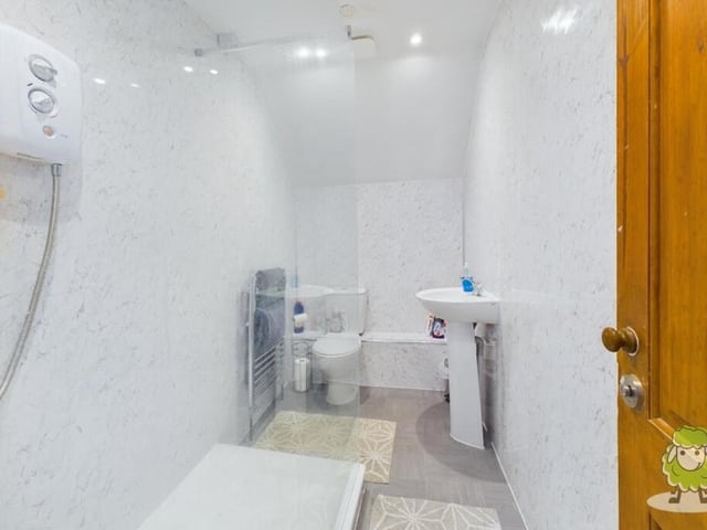 This is the first of two bathrooms that are located on the first floor, serving all five bedrooms.